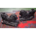 A pair of black painted reconstituted garden lions,