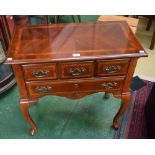 A reproduction side table, oversailing rectangular top above two long drawers, serpentine apron,