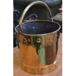 A late 19th century brass Arts and Crafts log bin, swing handle,