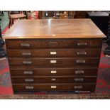 A mid-20th century oak plan chest, rounded rectangular top above six long drawers,