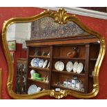 A contemporary 'gilt' framed wall mirror, crested by a shell flanked by scrolling acanthus,