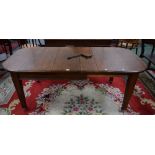 An Arts and Crafts period oak wind-out dining table, two additional leaves, c.