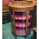 An early-mid 20th century mahogany bow fronted display cabinet, ball and claw feet,