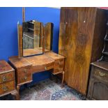 A 20th century walnut veneered wardrobe;