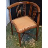 An Edwardian mahogany inlaid corner armchair, spindle back, pierced Arts and Crafts style splats,
