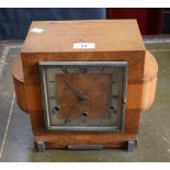 An Art Deco walnut mantel clock, 13cm square silvered dial, bold Roman numerals, minute track, 23.