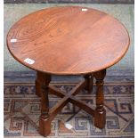 A 20th century oak occasional table, near-circular top, quadform base, turned legs, 50.