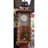 An early 20th century Vienna wall clock, cream dial, Roman numerals, eagle finial,