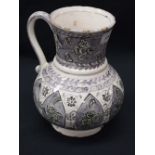 A Middle Eastern tin glazed earthenware baluster jug,