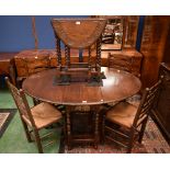 A 20th century oak gateleg dining table; a set of four conforming rush seated dining chairs;