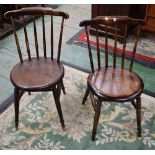 A spindle back side chair, shaped cresting rail, circular seat, turned tapered cylindrical legs,