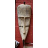 Tribal Art - a Fang Ngil mask, typical concave features with scarified cheeks, 77cm high,