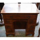 A 20th century walnut kneehole desk, of small proportions,