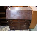 A 19th century oak bureau, fall front enclosing an arrangement of small drawers,