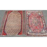 A hand knotted carpet decorated with geometric motifs on a vermilion ground,