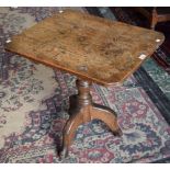 A 19th century oak occasional table, rounded rectangular top, turned baluster column, triform base,
