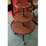 A 20th century mahogany three tier dumbwaiter, graduated circular stands,