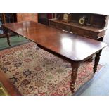 A William IV style mahogany extending dining table, rounded rectangular top, turned legs,