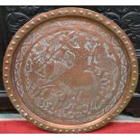 An Islamic copper charger, embossed with huntsman birds and foliage,