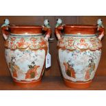 A pair of Japanese Kutani vases, the rims with moulded figures,