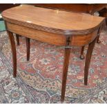 A 19th century mahogany tea table, reeded top above a deep frieze, sabre legs,