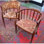 An Edwardian mahogany elbow chair, curved cresting and arm rails terminating in scrolls,