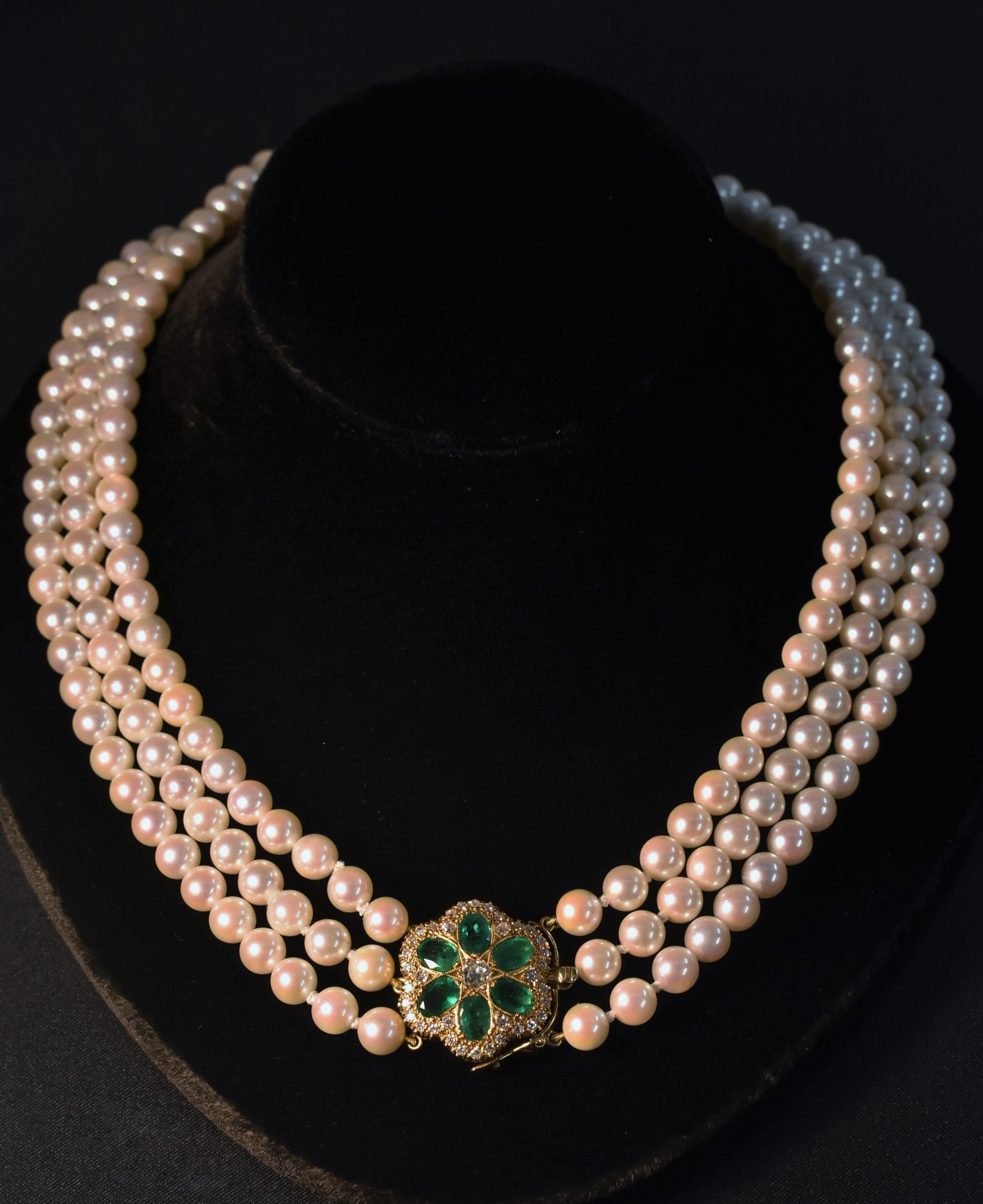 String of Pearls A three strand cultured pearl necklace,