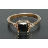 A black and white diamond dress ring, central princess cut square black diamond approx 1.