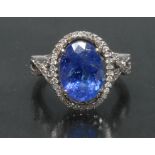 A contemporary certified tanzanite and diamond 14ct white gold cluster ring,