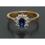 A diamond and sapphire cluster ring, central oval mid blue sapphire approx 0.