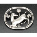 A Georg Jensen silver brooch designed by Arno Malinowski, open cast with a kneeling deer,