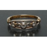 An unusual diamond trilogy ring, open arched oval crest mount,