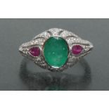 An emerald, ruby and diamond cluster ring, central oval deep green emerald approx 1.
