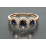 A blue sapphire and diamond cluster ring,