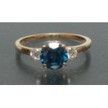 A fancy blue and white diamond trilogy ring, central round brilliant cut blue diamond, approx 1.