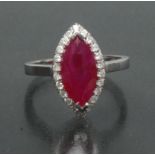 A ruby and diamond marquise ring, central vibrant red marquise ruby approx 2.