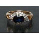 A sapphire and diamond cluster ring, central oval deep blue sapphire approx 1.