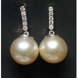 A pair of cultured south sea pearl and diamond earrings,