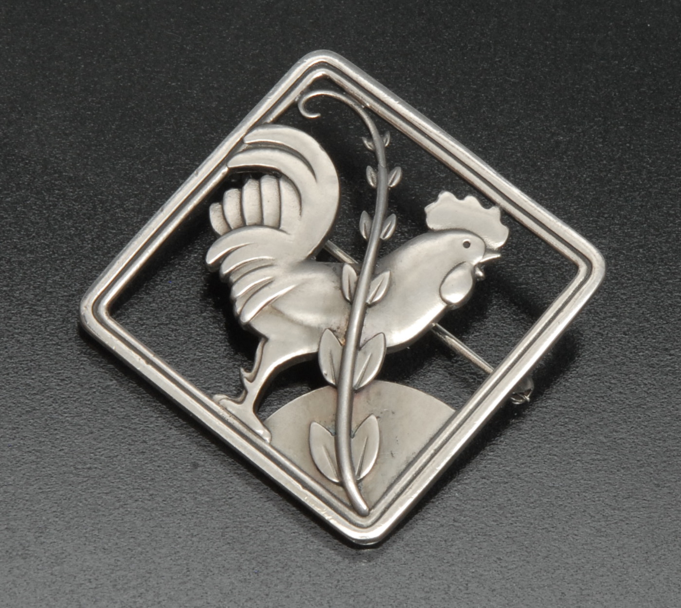 A Georg Jensen silver brooch designed by Arno Malinowski, open cast with a standing cockeral ,