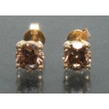 A pair of cognac diamond stud earrings, each round brilliant cut diamond approx 0..