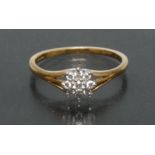 A diamond floral cluster ring, central round brilliant cut diamond,