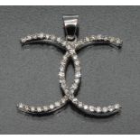 A contemporary certified diamond Chanel style crossed Cs shaped pendant,