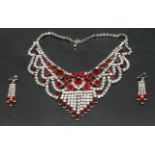 An impressive costume jewellery necklace and earrings set with red and white paste stones,
