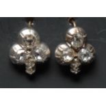A pair of diamond three stone cluster earrings, each old cushion cut diamond approx 0.