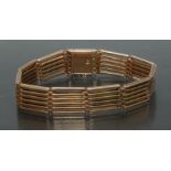 A 15ct gold six bar gate bracelet, stamped 15, 16cm long, 23.7g.