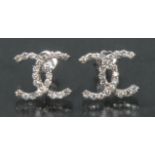 A pair of contemporary certified diamond Chanel style crossed Cs shaped earrings,