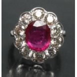 An impressive large diamond and ruby cluster ring, central large pinky red ruby,