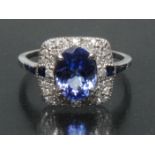 An Art Deco style tanzanite, sapphire and diamond ring, central oval violet blue tanzanite approx 1.
