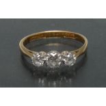 A diamond trilogy ring, central round brilliant cut diamond approx 0.