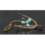 An Edwardian 15ct gold floral wishbone brooch,